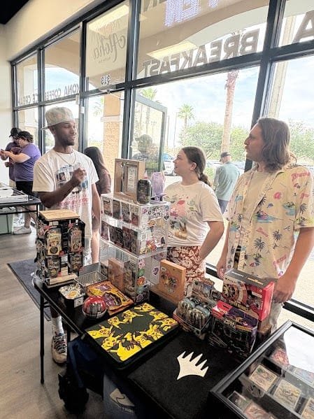 Vendors with Pokémon cards and collectibles at Aloha Waffle Bar